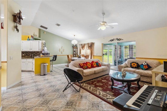 176 Hidden View Dr, Groveland, FL 34736 - living room with vaulted ceiling, ceiling fan, and baseboards