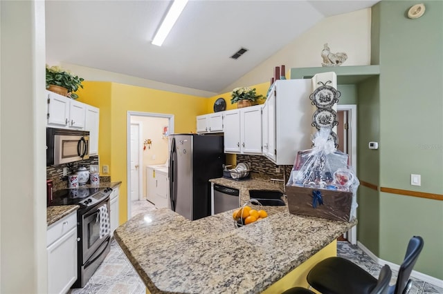 176 Hidden View Dr, Groveland, FL 34736 - kitchen featuring appliances with stainless steel finishes, a peninsula, decorative backsplash, a sink, and light stone countertops