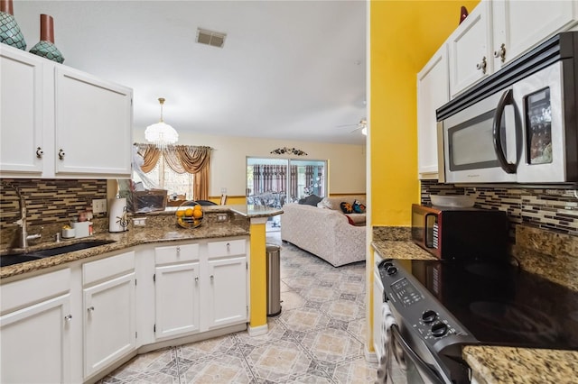 176 Hidden View Dr, Groveland, FL 34736 - kitchen featuring appliances with stainless steel finishes, white cabinetry, and decorative backsplash
