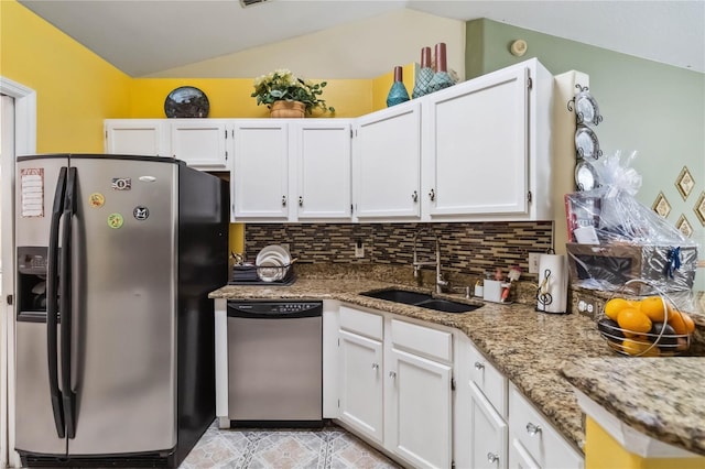 176 Hidden View Dr, Groveland, FL 34736 - kitchen featuring stainless steel appliances, a sink, lofted ceiling, white cabinetry, and light stone countertops