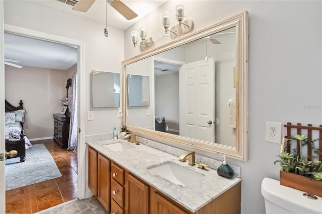 176 Hidden View Dr, Groveland, FL 34736 - ensuite bathroom with ceiling fan, double vanity, and toilet