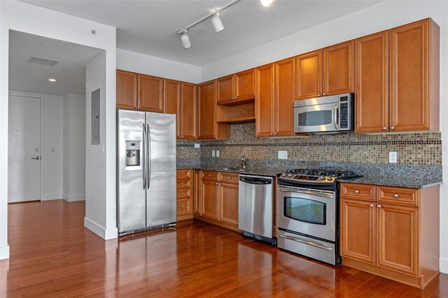 150 E Robinson St Unit 1023, Orlando, FL 32801 - kitchen featuring appliances with stainless steel finishes, dark wood-style floors, and decorative backsplash