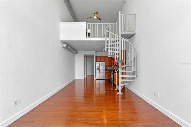 150 E Robinson St Unit 1023, Orlando, FL 32801 - staircase with a ceiling fan, wood finished floors, and a high ceiling