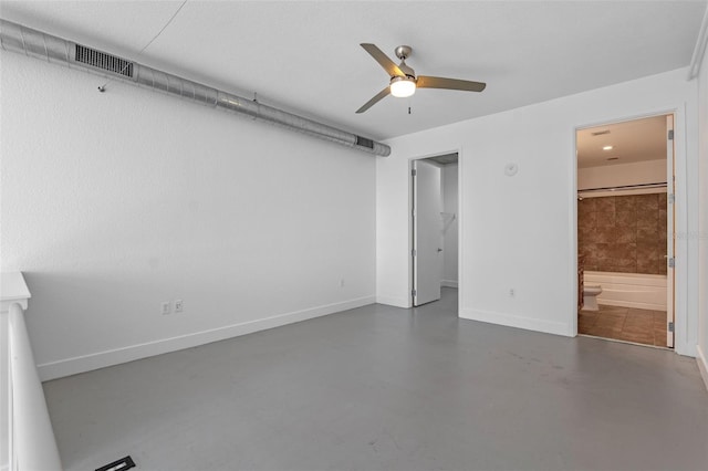 150 E Robinson St Unit 1023, Orlando, FL 32801 - unfurnished bedroom featuring finished concrete flooring, a walk in closet, ensuite bathroom, and ceiling fan