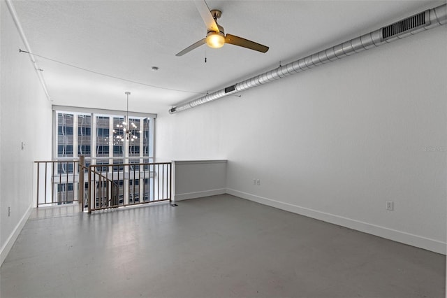 150 E Robinson St Unit 1023, Orlando, FL 32801 - spare room featuring a chandelier, concrete floors, and a ceiling fan