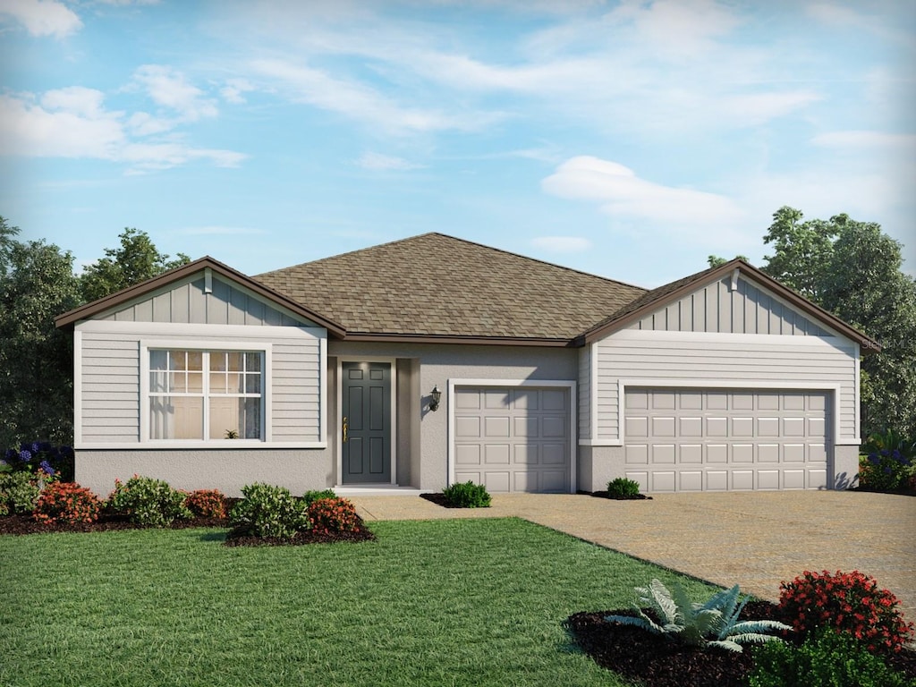 3136 Firethorn Cir, Daytona Beach, FL 32124 - ranch-style house with roof with shingles, an attached garage, a front lawn, and driveway