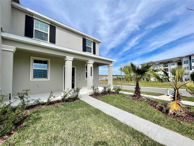 15579 Water Spring Blvd, Winter Garden, FL 34787 - view of front of home featuring stucco siding, a porch, and a front yard