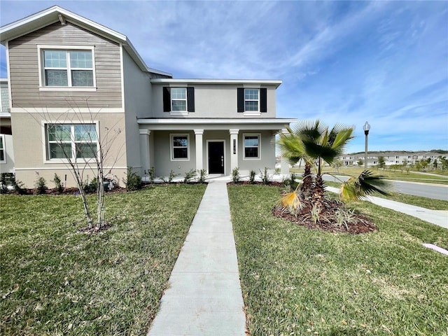 15579 Water Spring Blvd, Winter Garden, FL 34787 - view of front of property featuring stucco siding, a front lawn, and a porch