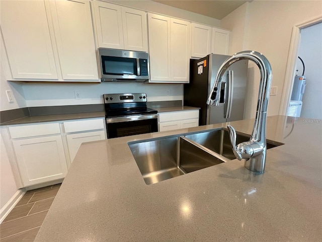 15579 Water Spring Blvd, Winter Garden, FL 34787 - kitchen featuring stainless steel appliances, white cabinets, and dark countertops