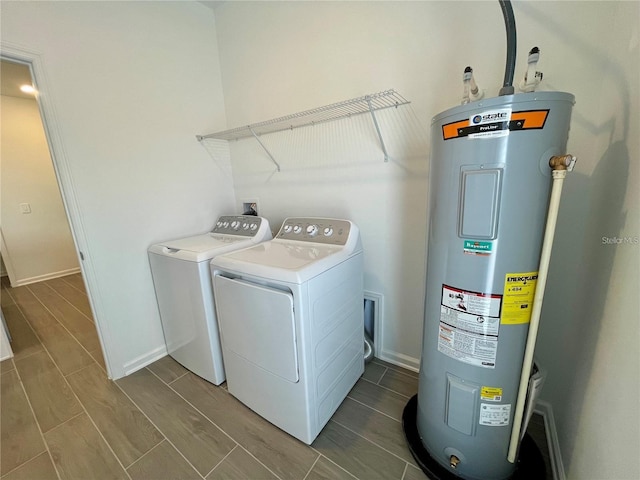 15579 Water Spring Blvd, Winter Garden, FL 34787 - laundry area featuring electric water heater, washer and clothes dryer, and wood finish floors