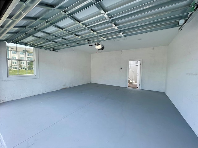 15579 Water Spring Blvd, Winter Garden, FL 34787 - garage with a garage door opener and concrete block wall