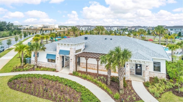 15579 Water Spring Blvd, Winter Garden, FL 34787 - view of front of property featuring stone siding, a residential view, a shingled roof, and stucco siding