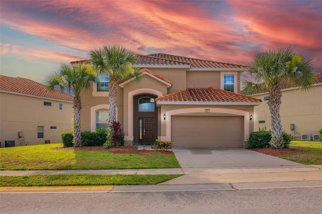 381 Cabello Dr, Davenport, FL 33837 - mediterranean / spanish-style house featuring a tiled roof, a garage, concrete driveway, stucco siding, and a front lawn