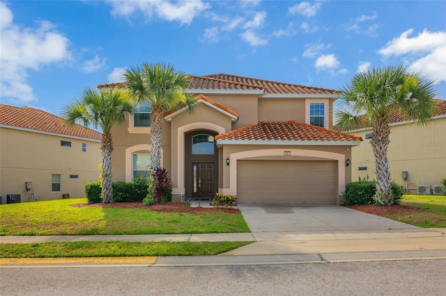 381 Cabello Dr, Davenport, FL 33837 - mediterranean / spanish-style house featuring a garage, a tiled roof, stucco siding, driveway, and a front yard