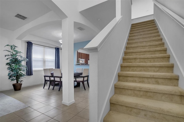 381 Cabello Dr, Davenport, FL 33837 - staircase with tile patterned floors and baseboards