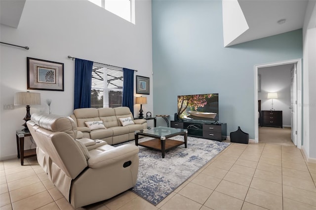 381 Cabello Dr, Davenport, FL 33837 - living area with a towering ceiling, light tile patterned floors, plenty of natural light, and baseboards
