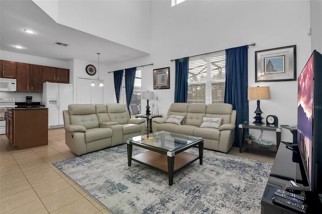 381 Cabello Dr, Davenport, FL 33837 - living area featuring light tile patterned floors, a high ceiling, and recessed lighting
