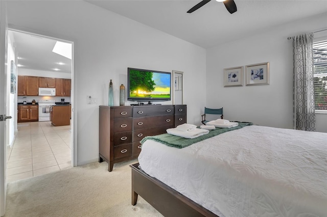 381 Cabello Dr, Davenport, FL 33837 - bedroom featuring light carpet, light tile patterned floors, ceiling fan, and baseboards