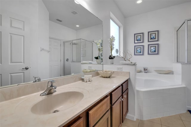 381 Cabello Dr, Davenport, FL 33837 - bathroom with a bath, vanity, a stall shower, and tile patterned floors