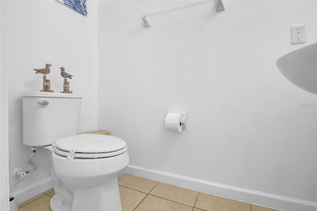 381 Cabello Dr, Davenport, FL 33837 - bathroom with baseboards, tile patterned floors, and toilet