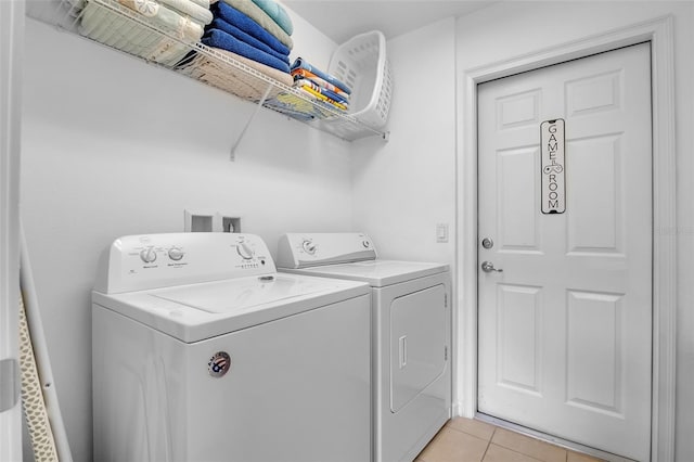 381 Cabello Dr, Davenport, FL 33837 - laundry room featuring washer and dryer and light tile patterned flooring