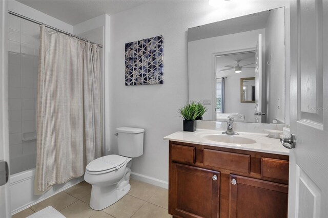 381 Cabello Dr, Davenport, FL 33837 - bathroom with vanity, toilet, tile patterned floors, shower / tub combo, and a ceiling fan