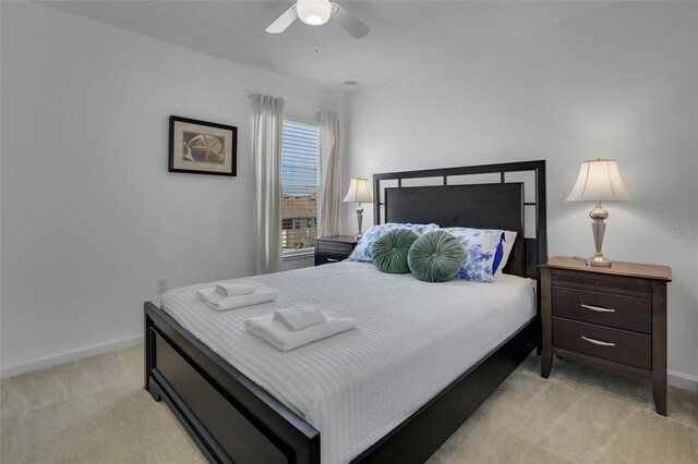 381 Cabello Dr, Davenport, FL 33837 - bedroom with light carpet, baseboards, and a ceiling fan