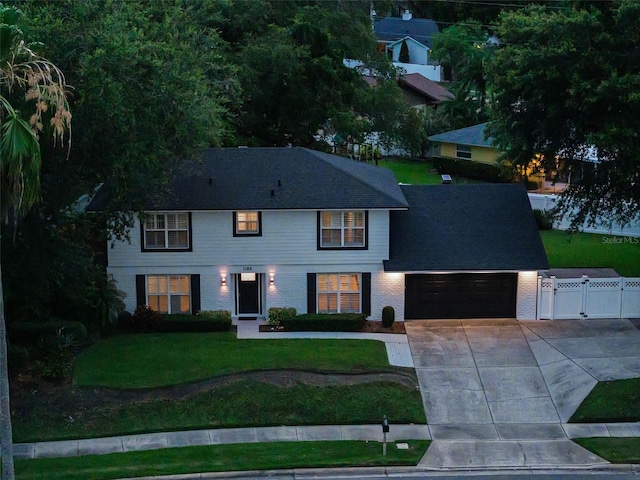 1105 Appleton Ave, Orlando, FL 32806 - colonial house with a garage, driveway, a gate, and brick siding