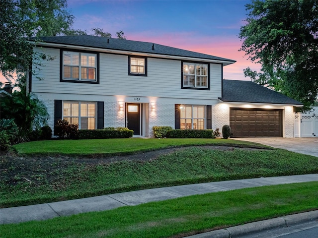 1105 Appleton Ave, Orlando, FL 32806 - view of front facade featuring a garage, brick siding, and driveway
