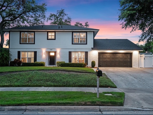 1105 Appleton Ave, Orlando, FL 32806 - view of front of property featuring a garage, driveway, and brick siding