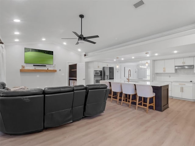 1105 Appleton Ave, Orlando, FL 32806 - living area with crown molding, ceiling fan, light wood-type flooring, lofted ceiling, and recessed lighting