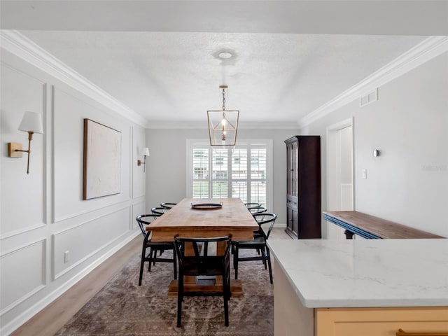 1105 Appleton Ave, Orlando, FL 32806 - dining area featuring ornamental molding and wood finished floors