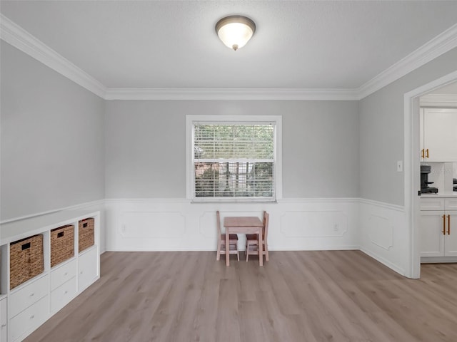1105 Appleton Ave, Orlando, FL 32806 - spare room featuring ornamental molding, light wood-type flooring, and a wainscoted wall