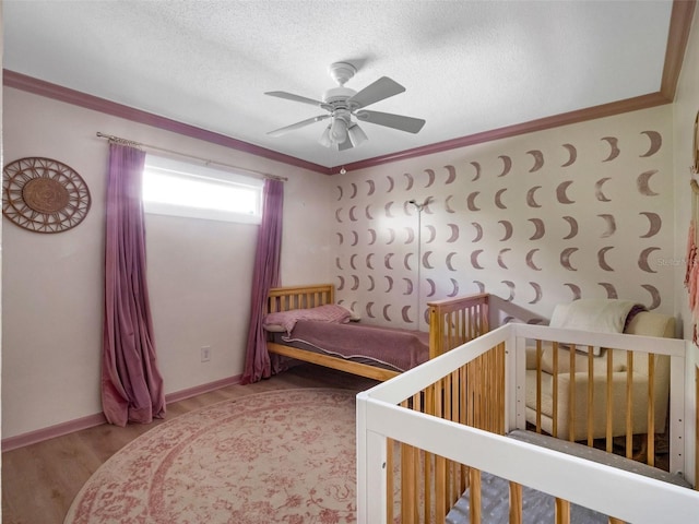 1105 Appleton Ave, Orlando, FL 32806 - bedroom featuring wood finished floors, ornamental molding, ceiling fan, and a textured ceiling