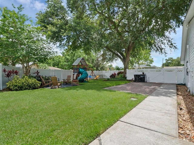 1105 Appleton Ave, Orlando, FL 32806 - fenced backyard featuring a playground, a patio, and a gate