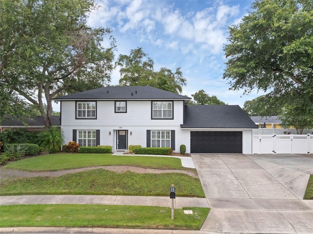 1105 Appleton Ave, Orlando, FL 32806 - colonial home with a garage, concrete driveway, and a gate