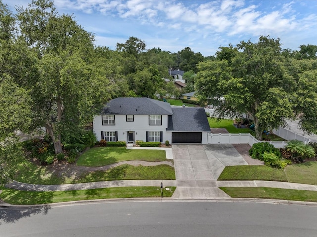 1105 Appleton Ave, Orlando, FL 32806 - colonial house with driveway, a garage, and roof with shingles
