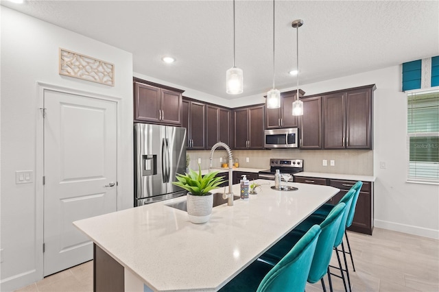 363 Miro Dr, Davenport, FL 33837 - kitchen with stainless steel appliances, recessed lighting, dark brown cabinetry, backsplash, and hanging light fixtures