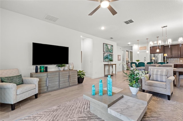 363 Miro Dr, Davenport, FL 33837 - living area with ceiling fan, recessed lighting, wood finish floors, and a chandelier
