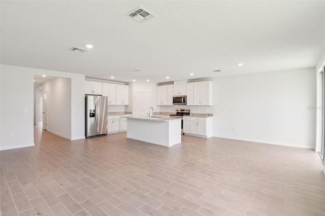 1732 Brekey Way, Zephyrhills, FL 33541 - kitchen featuring appliances with stainless steel finishes, open floor plan, light countertops, recessed lighting, and a kitchen island with sink