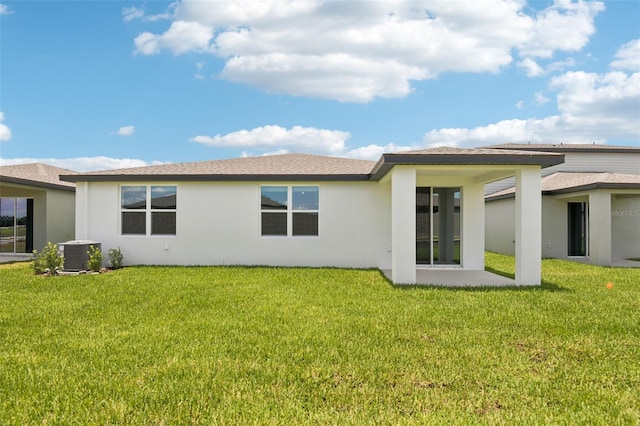 1732 Brekey Way, Zephyrhills, FL 33541 - rear view of property featuring stucco siding and a lawn