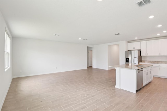 1732 Brekey Way, Zephyrhills, FL 33541 - kitchen with stainless steel appliances, open floor plan, recessed lighting, and light wood-type flooring