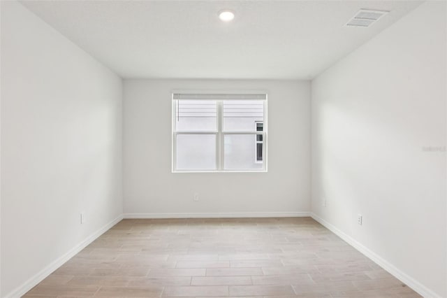 1732 Brekey Way, Zephyrhills, FL 33541 - unfurnished room featuring light wood-style floors and recessed lighting