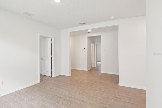 1732 Brekey Way, Zephyrhills, FL 33541 - spare room featuring light wood finished floors and a smoke detector