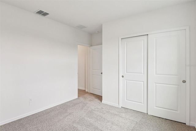 1732 Brekey Way, Zephyrhills, FL 33541 - unfurnished bedroom featuring light colored carpet and a closet
