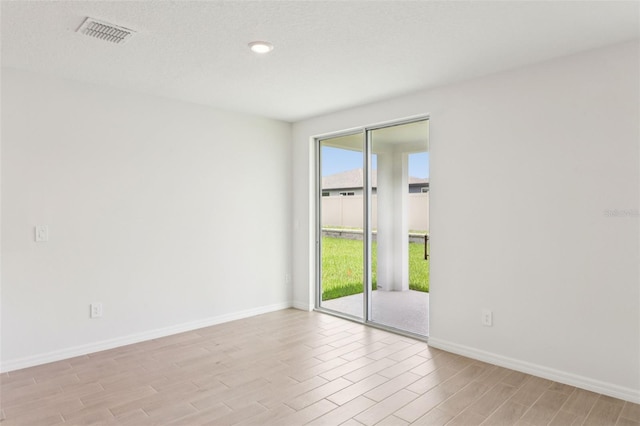 1732 Brekey Way, Zephyrhills, FL 33541 - spare room with light wood-style floors and baseboards
