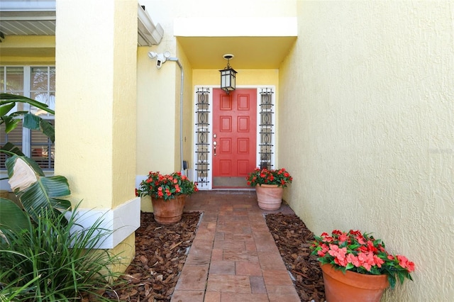 2205 Wyndam Way, Kissimmee, FL 34743 - doorway to property with a wall mounted AC and stucco siding