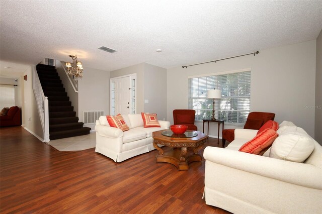 2205 Wyndam Way, Kissimmee, FL 34743 - living area with wood finished floors, stairs, a chandelier, and a textured ceiling