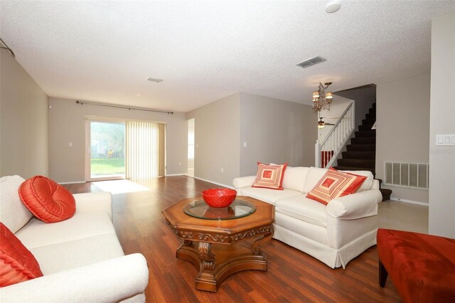 2205 Wyndam Way, Kissimmee, FL 34743 - living room featuring wood finished floors, stairs, a chandelier, and a textured ceiling