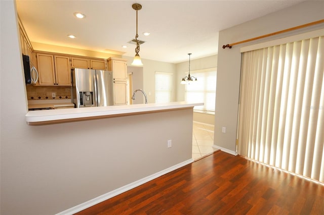 2205 Wyndam Way, Kissimmee, FL 34743 - kitchen with appliances with stainless steel finishes, decorative light fixtures, recessed lighting, dark wood-style floors, and a peninsula